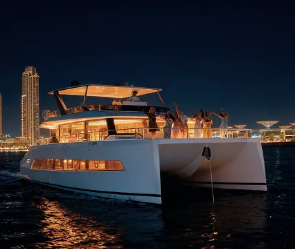 Luxury Yacht NYE Party: Guests Celebrating on Illuminated Yacht with Dubai Skyline